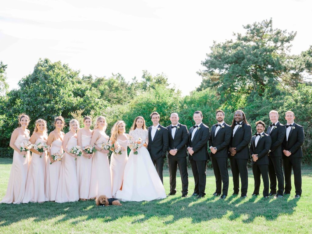 Wedding party with groomsmen in black tuxes and bridesmaids in Champagne colored dresses 