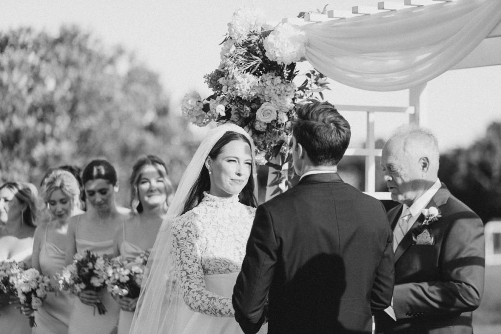 bride looking emotionally at her groom during wedding vows