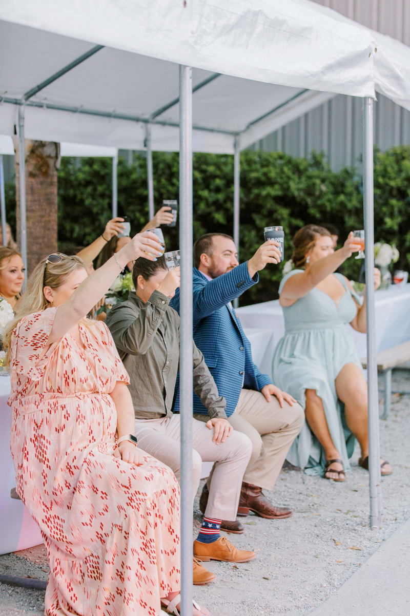 guests toasting at same sex wedding