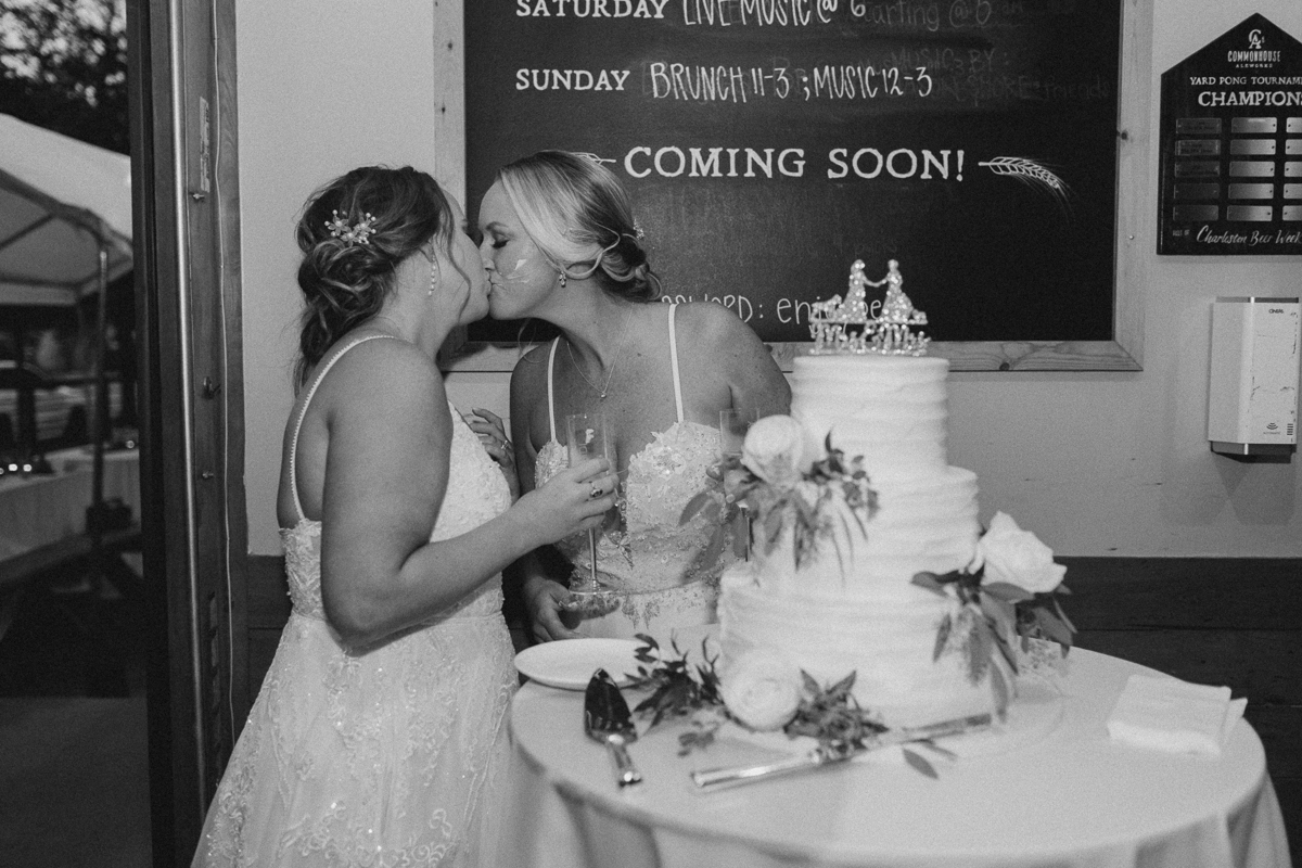 cake cutting kiss at lgbtq wedding