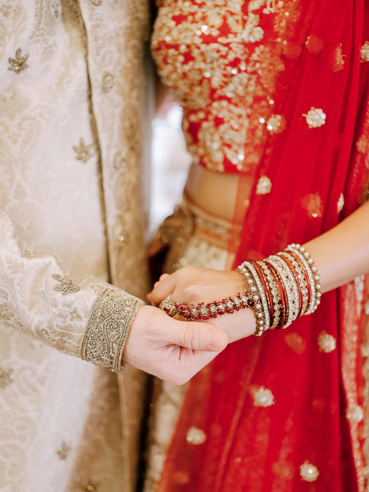 Indian Wedding Couple Jewelry and Red Saree and Tan sherwani