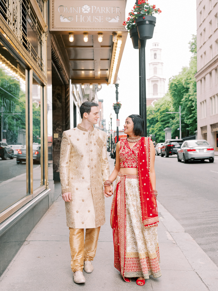 Indian Wedding Bride and Groom at Omni Parker Hotel in Boston in a Red and Tan Saree and Tan sherwani
