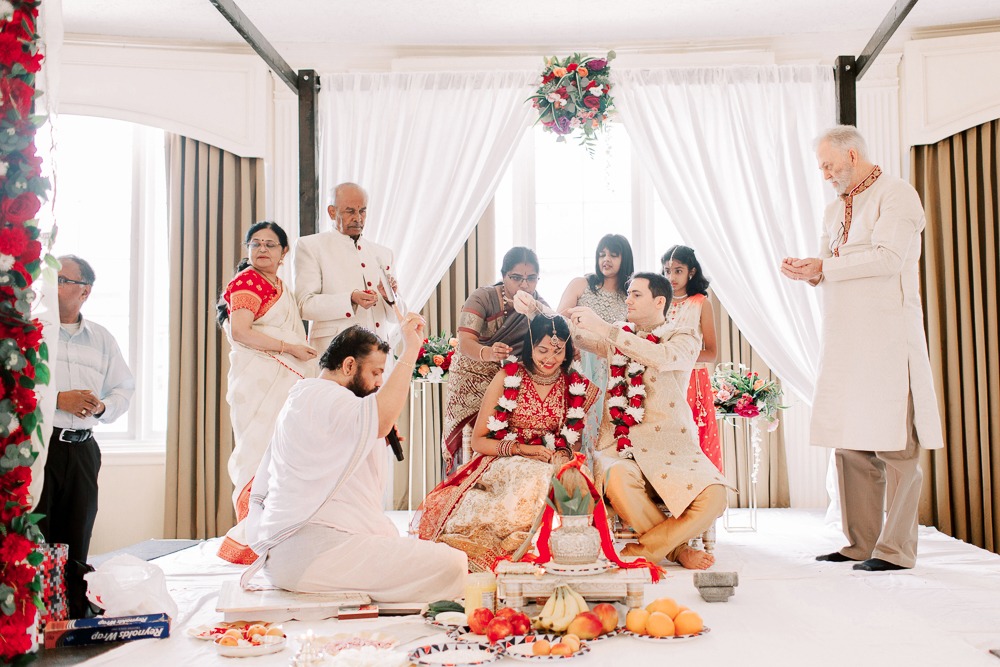 Bride and Groom with Families during Indian Wedding Ceremony
