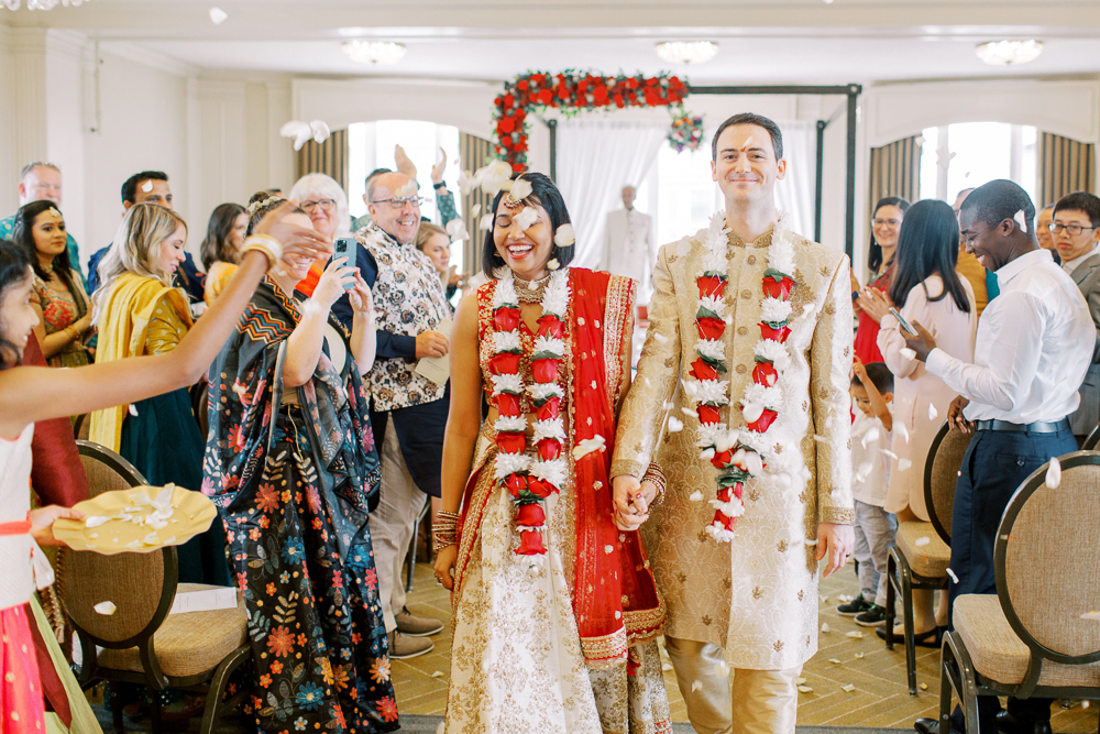 Indian Wedding Bride and Groom exiting Hindu Ceremony with Flower Petal Confetti