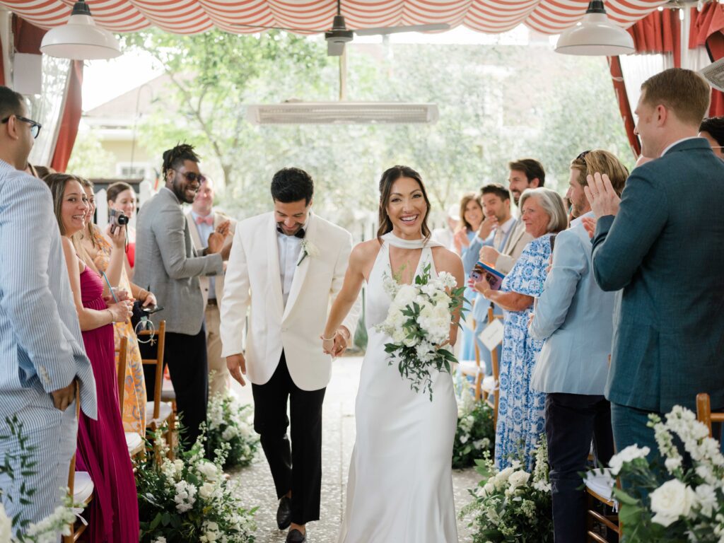 Bride and groom exiting ceremony at Post House Inn | Charleston Wedding Photographer